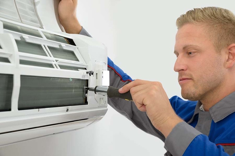 man performing an AC tune-up