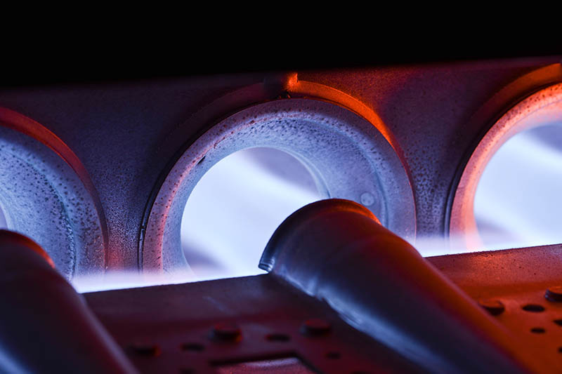 Closeup Shot Of Home Furnace Burner Ignited With Crimson Blue Flame, Furnace