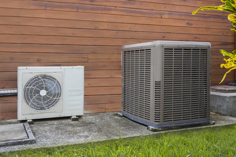 Air conditioning heat pumps on the side of a house