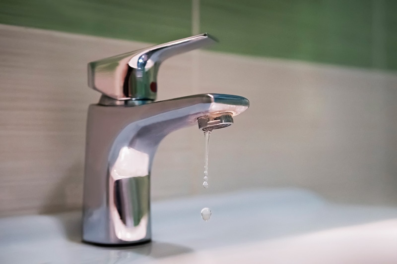 Close up of a leaky faucet, What Questions Should You Ask Before Hiring a Plumber? | Plumbing