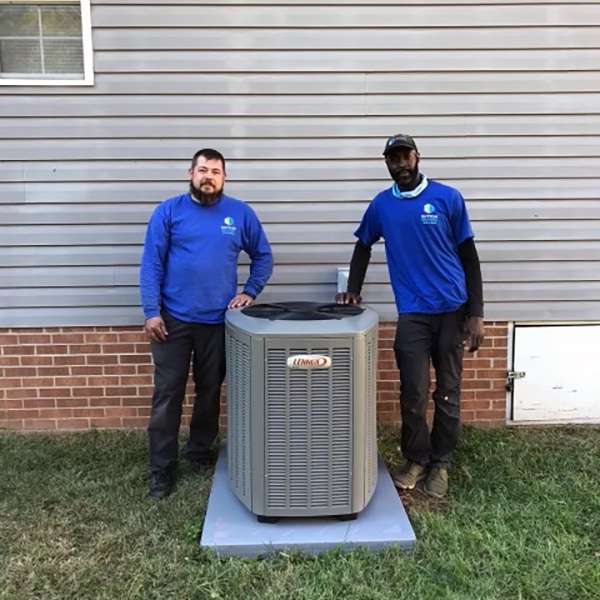 Sutton Brothers technicians standing next to a high-efficiency Lennox heating and cooling system.